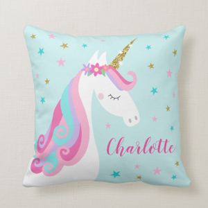 Unicorn pillow with flowers and gold glitter, aqua background with stars and personalized name.