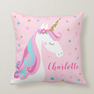 Unicorn pillow with flowers and gold glitter, pink background with stars and personalized name.