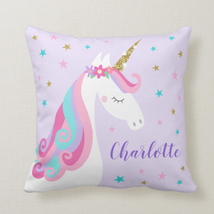Unicorn pillow with flowers and gold glitter, purple background with stars and personalized name.