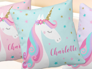 Unicorn pillows with rainbow unicorn, glitter, flowers and stars in aqua, pink and purple.