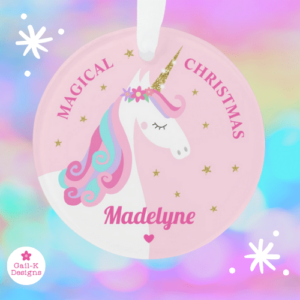 Unicorn Christmas ornament with a cute rainbow unicorn, flowers and gold glitter stars on a pink background.