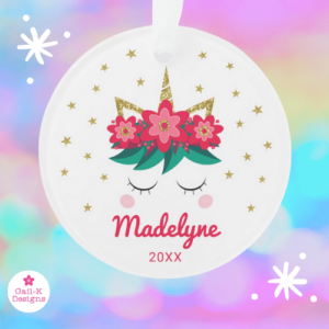 Personalized round unicorn Christmas ornament with red flowers, berries, gold glitter and stars.