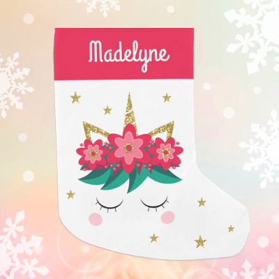 Personalized festive unicorn Christmas stocking with glitter and red flowers.