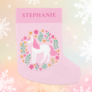 Pink unicorn Christmas stocking with pink and orange flowers and personalized name.