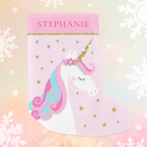 Cute unicorn Christmas stocking with rainbow unicorn and glitter on a pink background.
