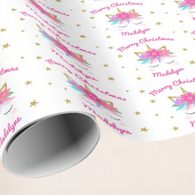 Personalized unicorn christmas wrapping paper with cute unicorn face, pink flowers and stars.