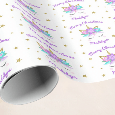Personalized unicorn christmas wrapping paper with cute unicorn face, purple flowers and stars.
