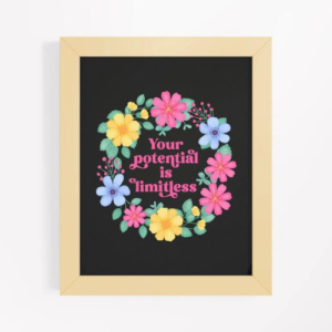 Motivational wall art with yellow, pink and blue floral wreath on black background with text: Your potential is limitless.