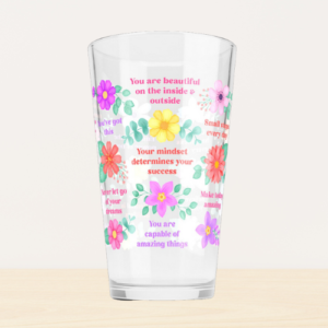 Motivational glass tumbler with inspirational quotes and vibrant flowers.