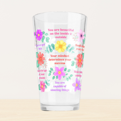 Inspirational glass tumbler with motivational quotes and vibrant flowers.