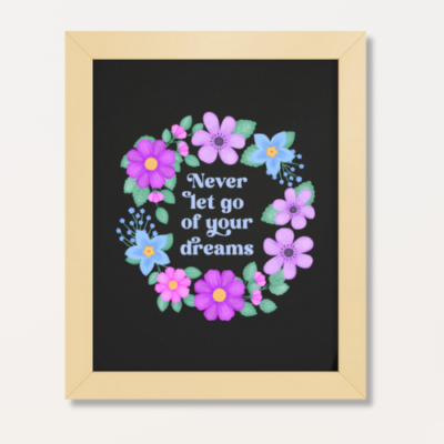 Motivational wall art with purple and blue floral wreath on black background with text: Never let go of your dreams