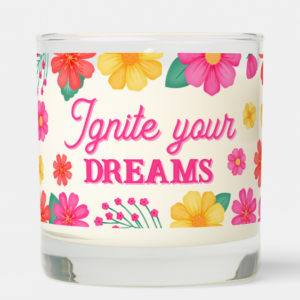 Inspirational candle with motivational quote: Ignite your dreams in script typography and pink, yellow and orange flowers.