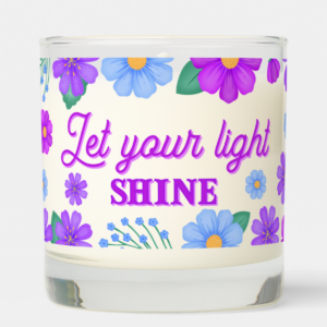 Inspirational candle with motivational quote: Let your light shine in script typography and purple and blue flowers.