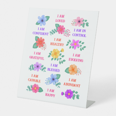 Positive affirmation station gift pedestal sign with customizable I am affirmations and vibrant floral design.